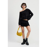 Emory Park Off Shoulder Distressed Top in black worn by model with black skirt and yellow handbag