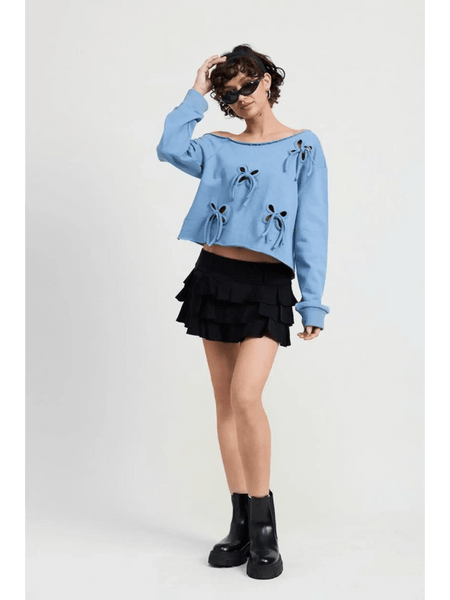 Emory Park Off Shoulder Distressed Top in blue worn with black ruffled skirt and black boots