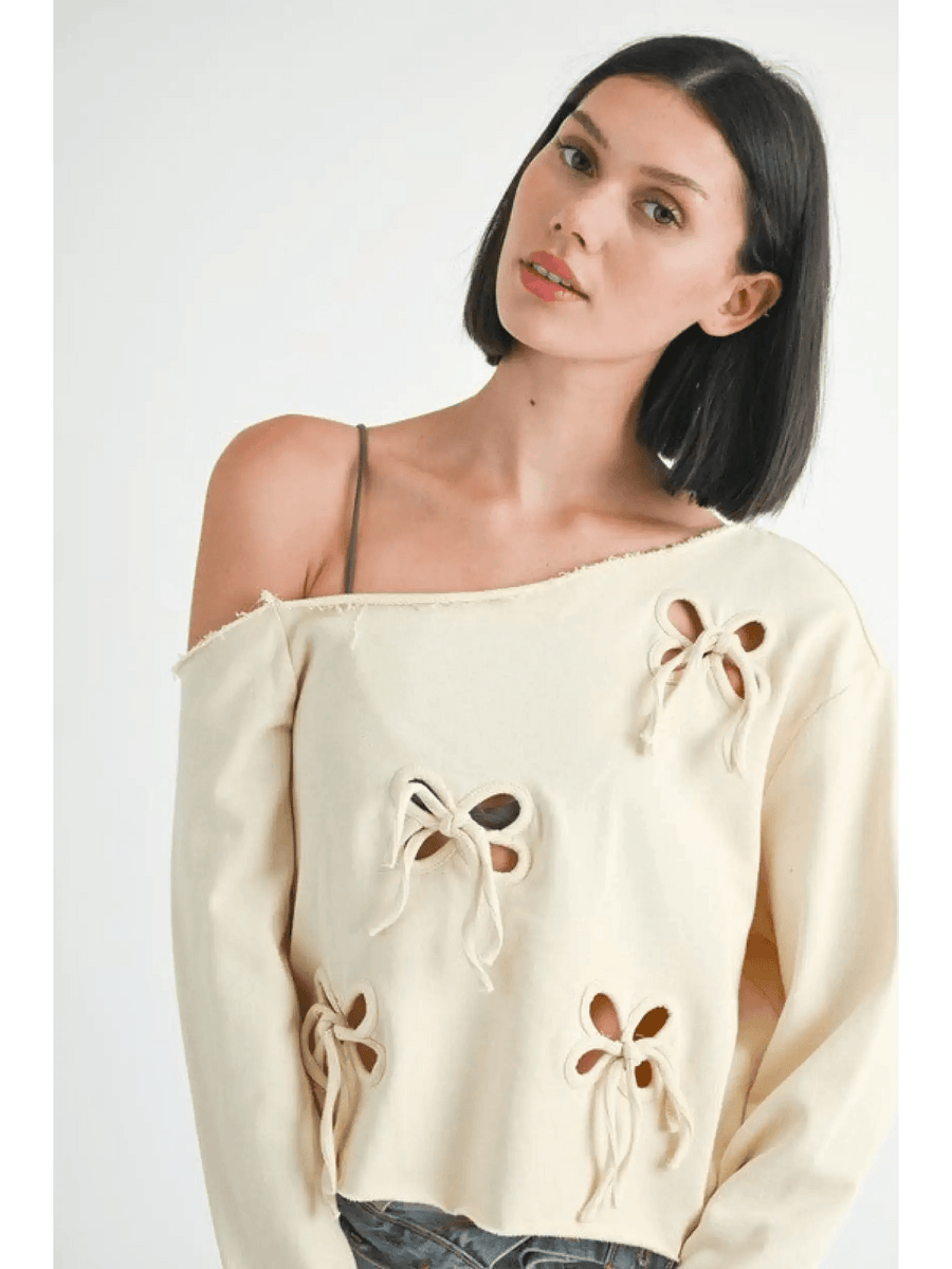 Emory Park Off Shoulder Distressed Top in beige with bow cutout details on long sleeves