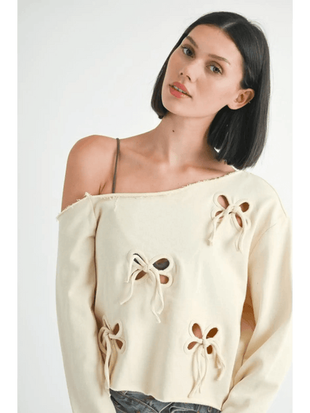 Emory Park Off Shoulder Distressed Top in beige with bow cutout details on long sleeves