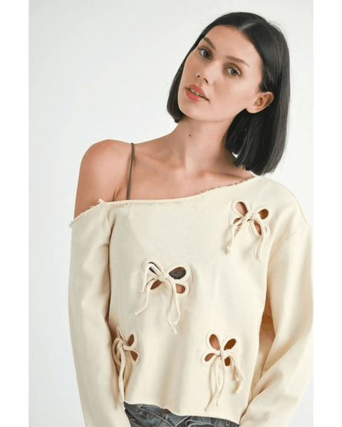 Emory Park Off Shoulder Distressed Top in beige with bow cutout details on long sleeves