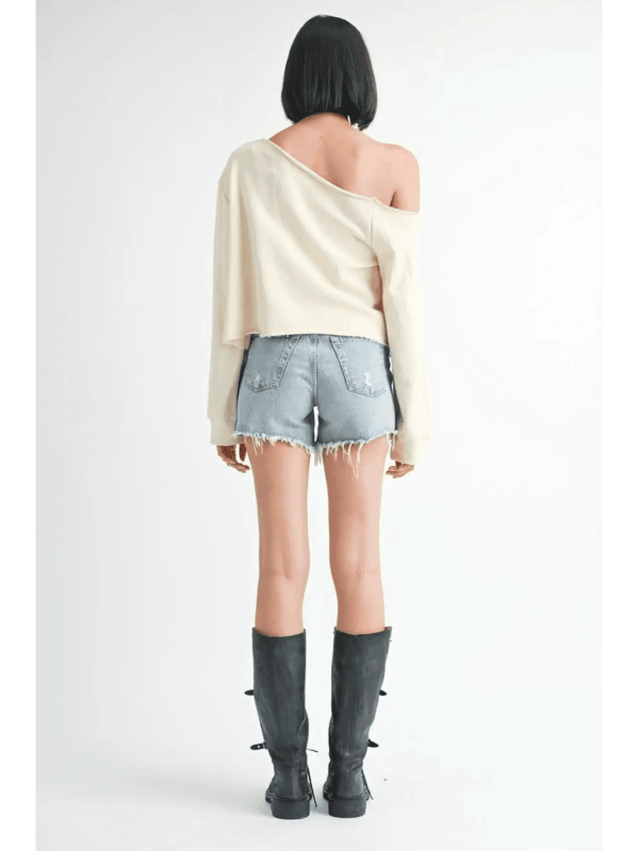 Emory Park off shoulder distressed top in cream worn with denim shorts and black boots