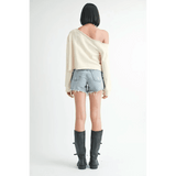 Emory Park off shoulder distressed top in cream worn with denim shorts and black boots