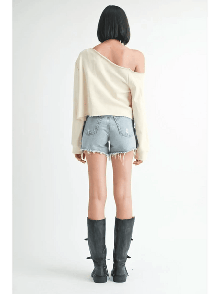 Emory Park off shoulder distressed top in cream worn with denim shorts and black boots