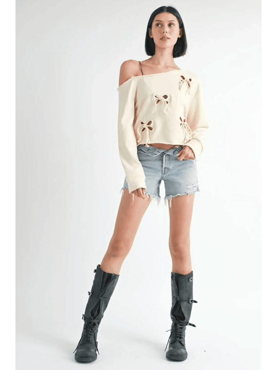 Emory Park Off Shoulder Distressed Top worn by model with denim shorts and black boots