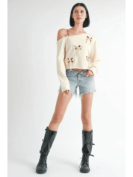 Emory Park Off Shoulder Distressed Top worn by model with denim shorts and black boots