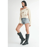 Emory Park Off Shoulder Distressed Top in cream worn with denim shorts and black boots