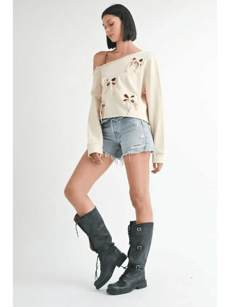 Emory Park Off Shoulder Distressed Top in cream worn with denim shorts and black boots