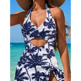 Beach Babes sexy cutout swim dress with navy palm tree print and halter neckline on beach background