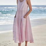Babe Beachwear pink flowy sundress for women midi dress with pockets worn at the beach