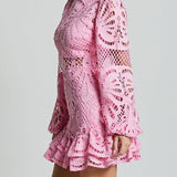 Pink lace mini dress with long sleeves and ruffled hem by Babe Beachwear