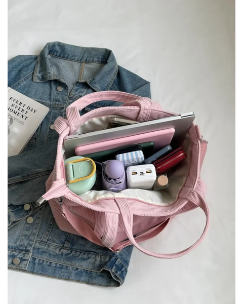 Lightweight ladies duffle bag in pink with multiple compartments, shown open with accessories inside