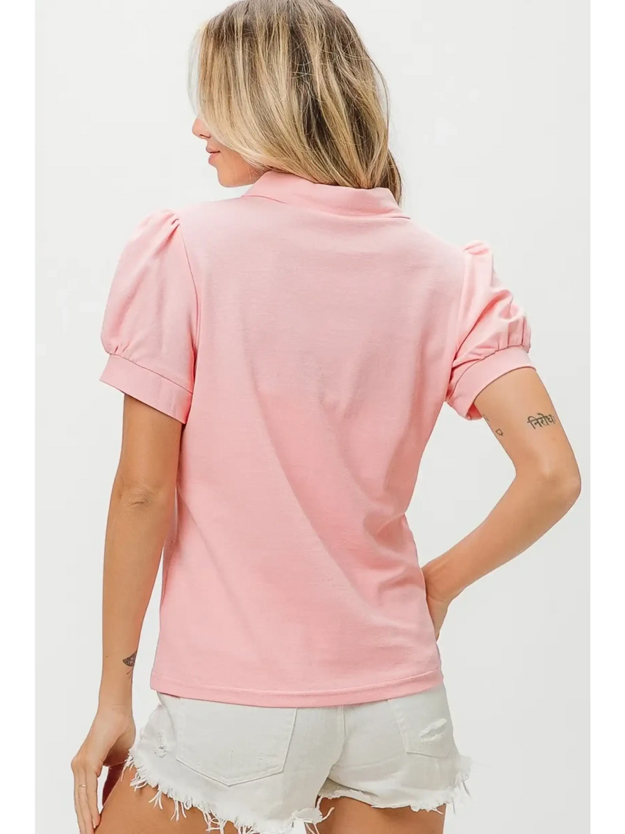 Back view of pink puff sleeve shirt for women by Trendsi paired with white distressed shorts
