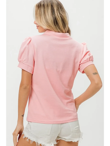 Back view of pink puff sleeve shirt for women by Trendsi paired with white distressed shorts
