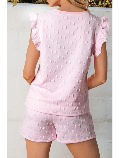 Back view of pink summer short set for women with bow pattern and ruffle sleeves