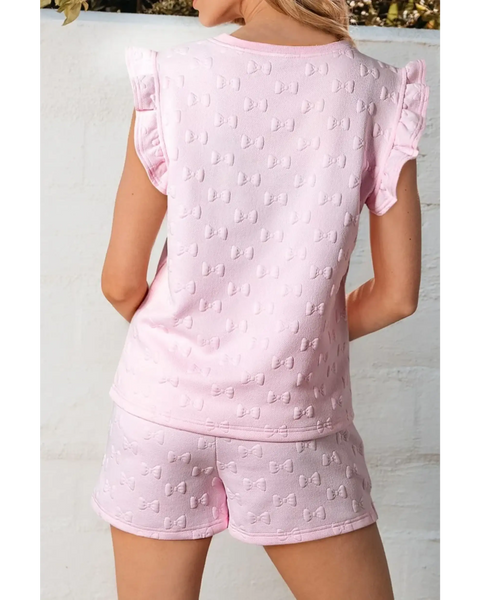 Back view of pink summer short set for women with bow pattern and ruffle sleeves