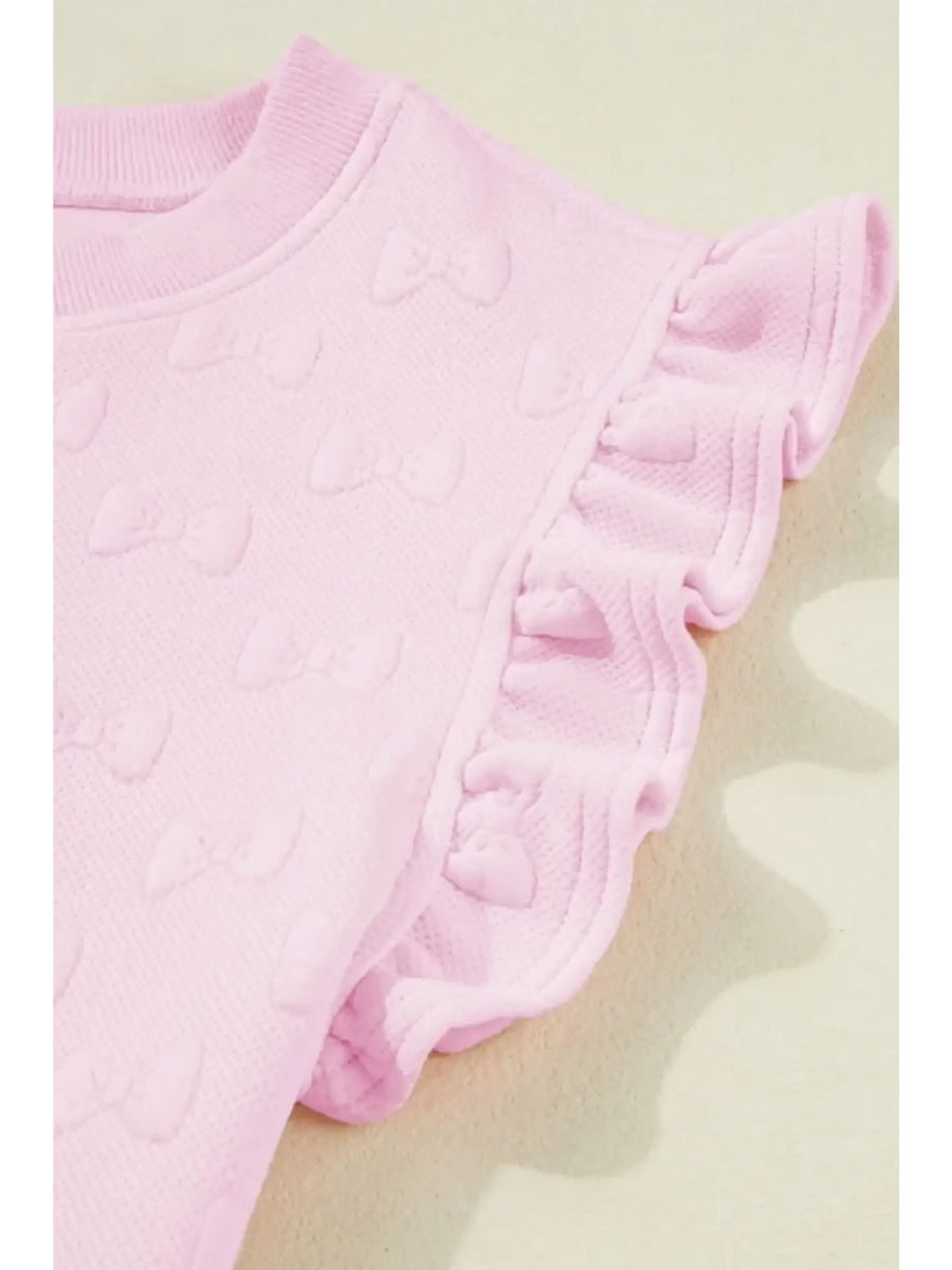 Close-up of pink summer short set for women with textured bow details and ruffled sleeves by Trendsi