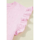 Close-up of pink summer short set for women with textured bow details and ruffled sleeves by Trendsi