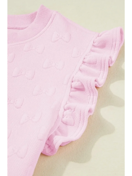 Close-up of pink summer short set for women with textured bow details and ruffled sleeves by Trendsi