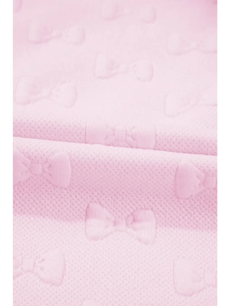Close-up of pink summer short set for women fabric with textured bow patterns by Trendsi