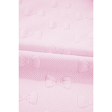 Close-up of pink summer short set for women fabric with textured bow patterns by Trendsi