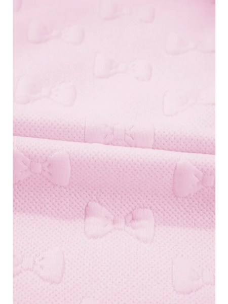 Close-up of pink summer short set for women fabric with textured bow patterns by Trendsi
