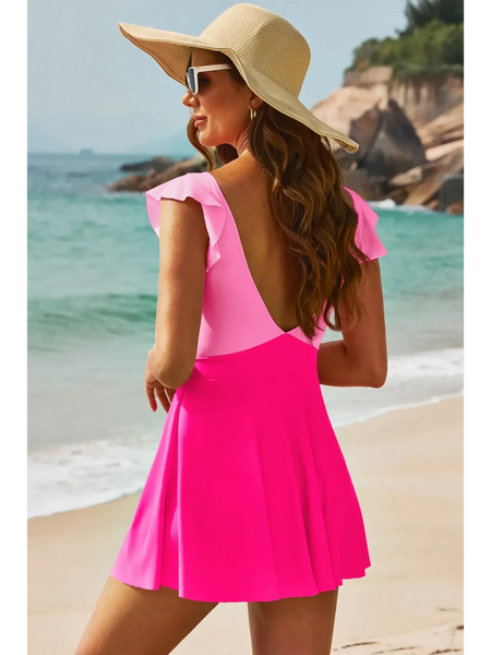 Beach Babes pink Swimdress Swimsuit with Coverage and Flowy Skirt worn by woman on beach