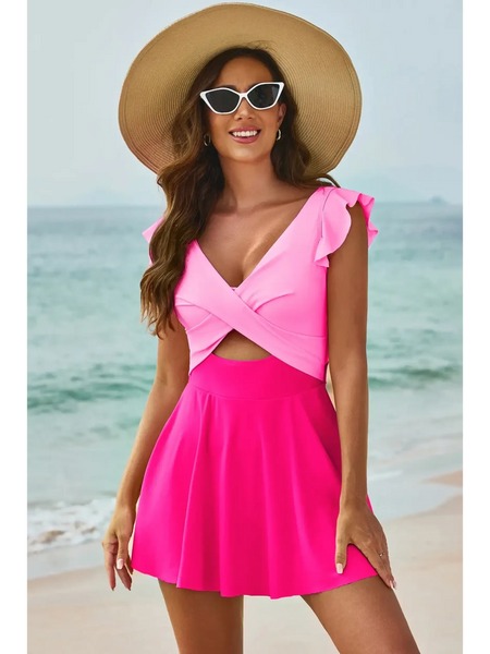 Beach Babes pink Swimdress Swimsuit with Coverage and Flowy Skirt worn by woman on the beach pink and coral 