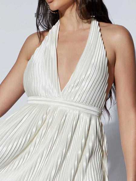 White pleated halter mini cocktail dress by Babe Beachwear with deep V neckline and flowing skirt