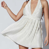 Babe Beachwear white pleated halter mini cocktail dress with deep V neckline and flowing skirt
