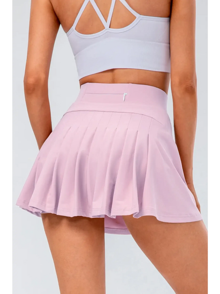 Babe Beachwaer pleated tennis skirt with pockets in light pink worn by model from the back