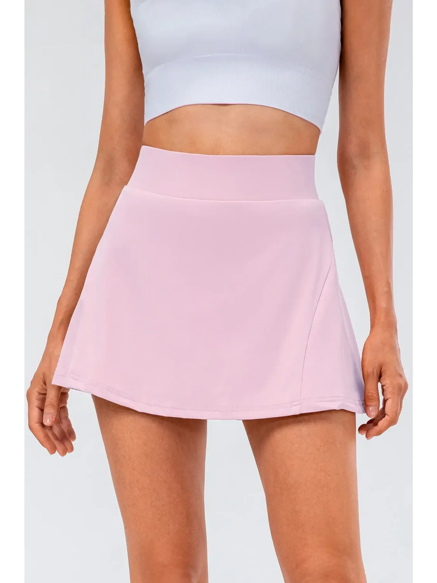 Babe Beachwear pleated tennis skirt with pockets in light pink worn with white crop top
