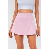 Babe Beachwear pleated tennis skirt with pockets in light pink worn with white crop top