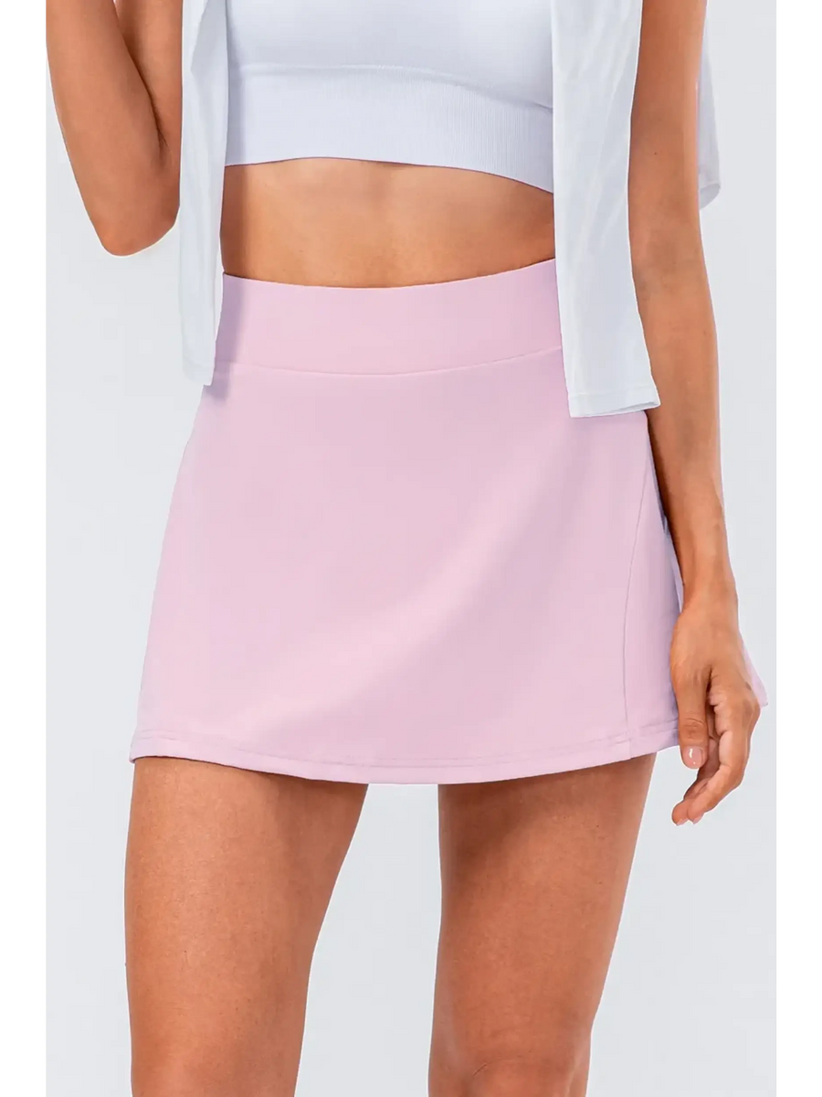 Babe Beachwear pink pleated tennis skirt with pockets worn with white crop top