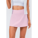 Babe Beachwear pink pleated tennis skirt with pockets worn with white crop top