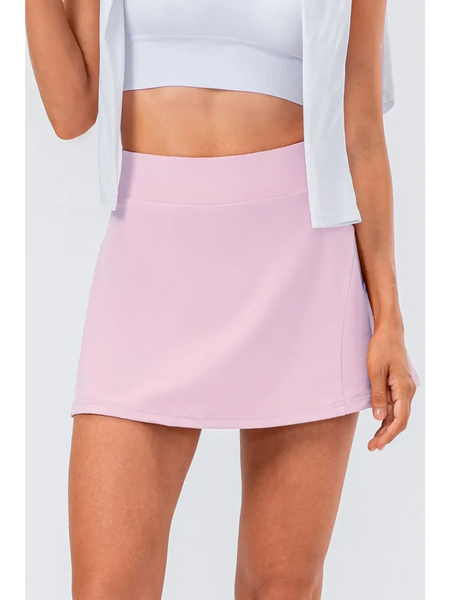 Babe Beachwear pink pleated tennis skirt with pockets worn with white crop top