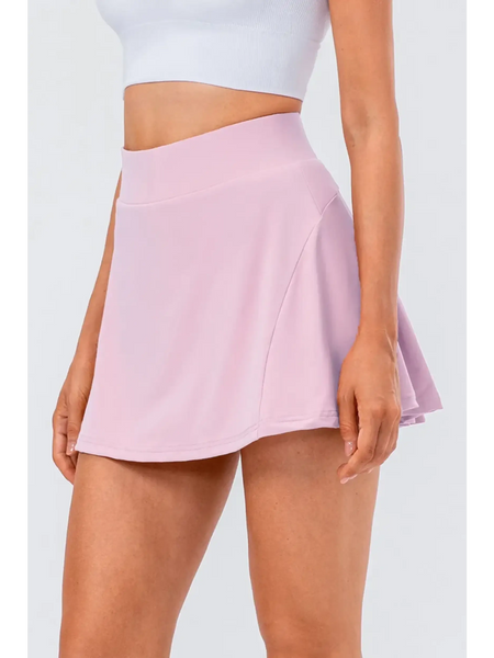 Babe Beachwaer light pink pleated tennis skirt with pockets worn with white crop top