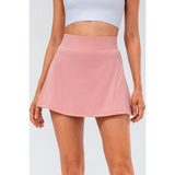 Babe Beachwear pleated tennis skirt with pockets in pink worn with white crop top