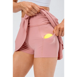 Babe Beachwear pleated tennis skirt with pockets in pink showing tennis ball pocket detail