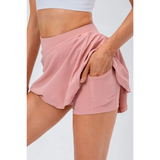 Babe Beachwear pleated tennis skirt with pockets in light pink, featuring built-in shorts and a high waistband