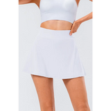 Babe Beachwear pleated tennis skirt with pockets in white modeled with white crop top