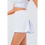 Babe Beachwear white pleated tennis skirt with pockets worn with white crop top