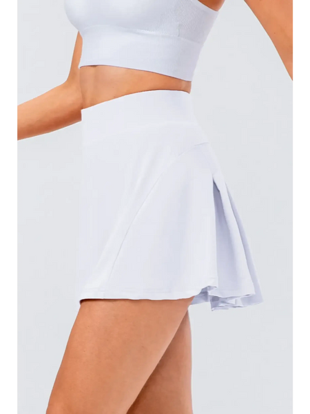 Babe Beachwear white pleated tennis skirt with pockets worn with white crop top