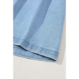 Close-up of light blue pleated wide leg denim shorts hem by Trendsi showing fabric texture
