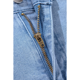 Close-up of zipper on Trendsi pleated wide leg denim shorts in blue fabric