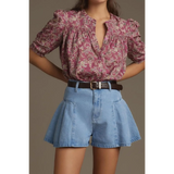 babe beachwear pleated wide leg denim shorts in light blue worn with a floral blouse and brown belt