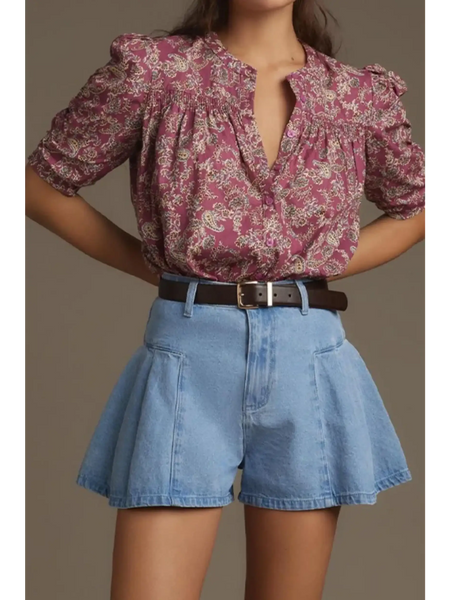 babe beachwear pleated wide leg denim shorts in light blue worn with a floral blouse and brown belt