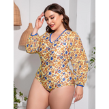Plus size one piece swimsuit with sleeves by Beach Babes featuring yellow floral pattern and blue trim
