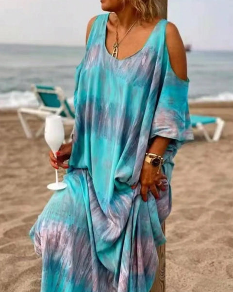 Trendsi plus size tie dye maxi dress in blue and purple with cold shoulder design worn at the beach