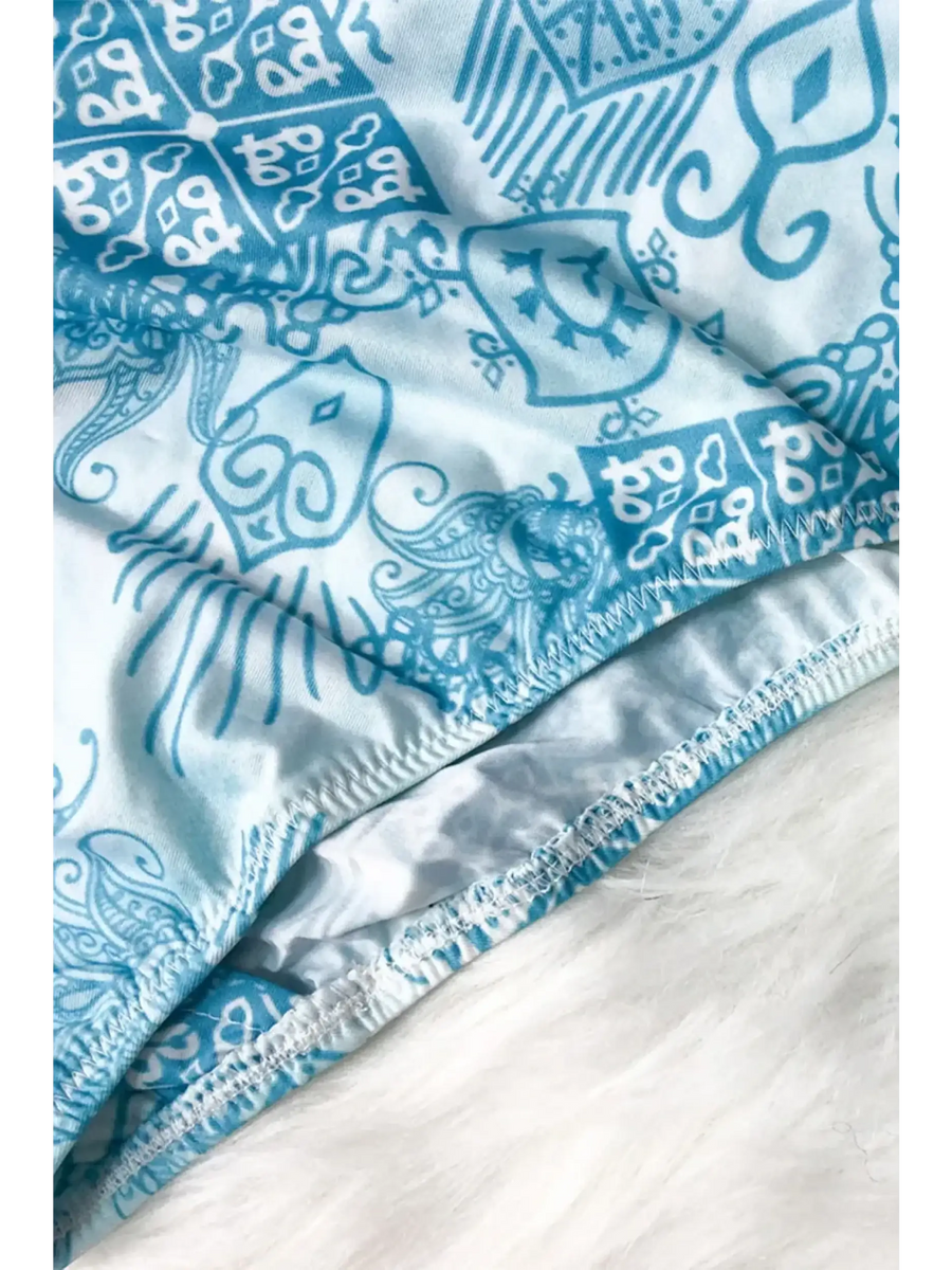 Close-up of Beach Babes sun protective swimwear for women with blue and white intricate pattern
